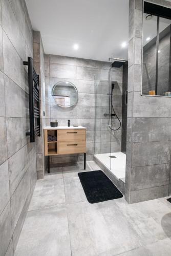 une salle de bain avec douche et lavabo dans l'établissement Cosy, moderne, central, standing, à Saint-Étienne
