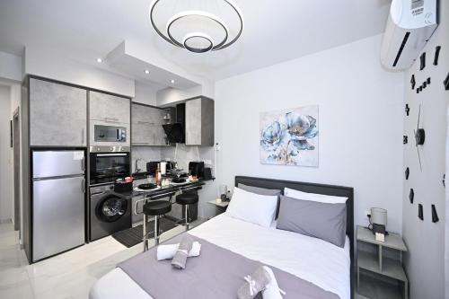 a small bedroom with a bed and a kitchen at Sea & Joy Studio in Ialyssos