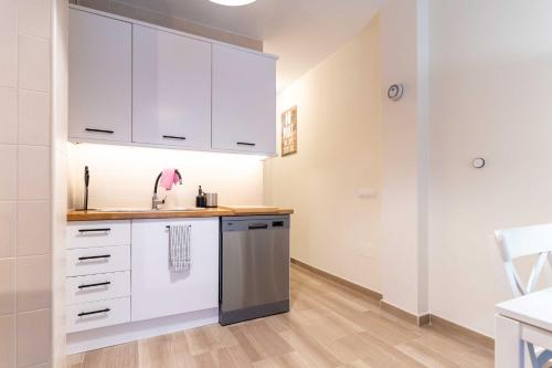 a kitchen with white cabinets and a sink at Fuengirola Centro Histórico. A 200 m de la playa in Fuengirola