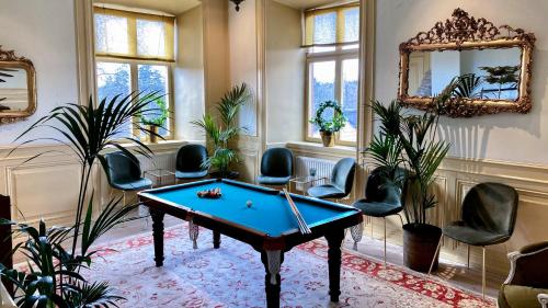 a room with a pool table and chairs at Görvälns Slott in Järfälla