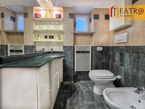 a bathroom with a toilet and a sink at Teatro al Centro in Ancona
