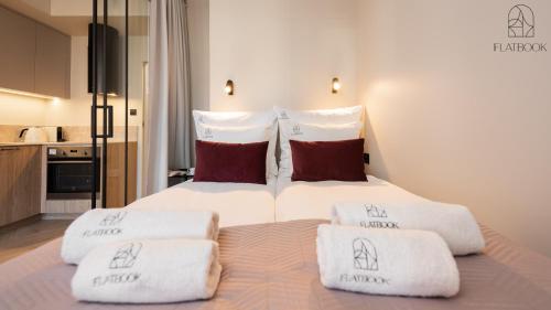 a bedroom with a bed with towels on it at Flatbook - Old Town Apartments GARNCARSKA II in Gdańsk