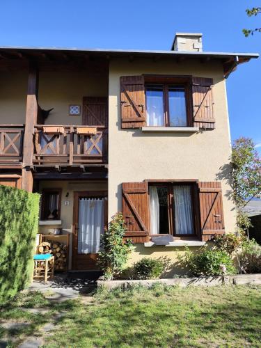 a building with wooden balconies on the side of it at L'avet blau in Sainte-Léocadie