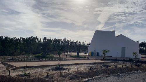 a large white building in the middle of a road at Vale das Estrelas in São Teotónio
