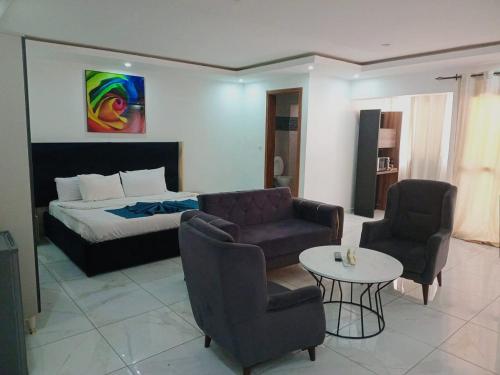 a hotel room with a bed and a table and chairs at Bi-Hotel 1 in Dakar