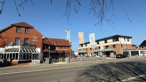 an empty street in a small town with buildings at App2-SD9 Dieksand in Friedrichskoog