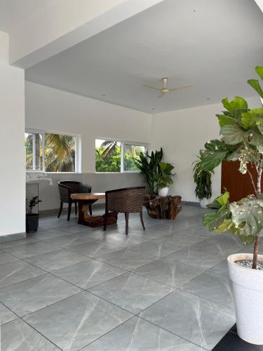 a living room with a table and some plants at Ahika Stays in Bengaluru