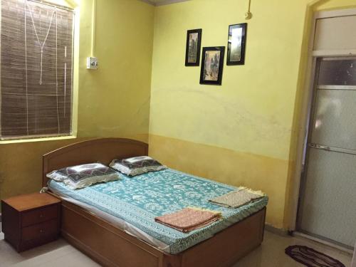 a bedroom with a bed in a room at Lilly Vacation Homes - Alibaug in Kīhīm