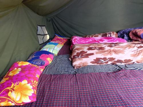 a bed in a tent with pillows on it at Himalayan Hill Camps By StayApart in Kedārnāth