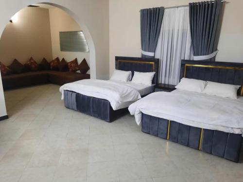 Postel nebo postele na pokoji v ubytování Morbex Inn Hotel Islamabad