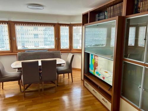 a dining room with a table and a fish tank at Appartamento FedElia a Tarvisio vicino al centro in Tarvisio