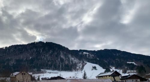 a snow covered mountain with a town in the foreground at Appartamento FedElia a Tarvisio vicino al centro in Tarvisio