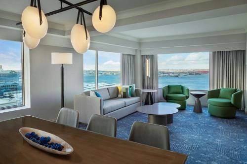 a living room with a couch and a table at Renaissance Boston Seaport District in Boston