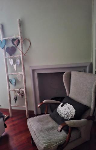 a chair with a pillow sitting next to a fireplace at Carducci in Como