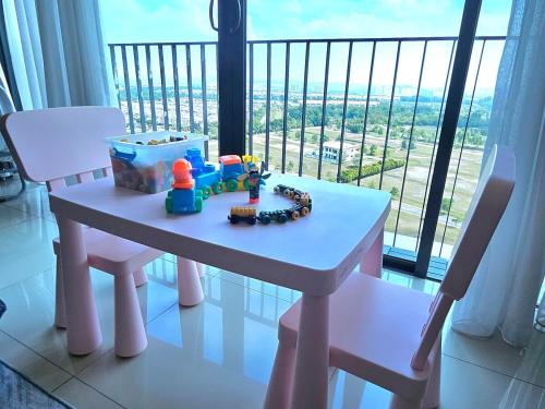 a table with a toy train on it in front of a window at Minimalist Trefoil studio Setia Alam linked bridge to SCCC and SCM for 2-4 pax in Setia Alam