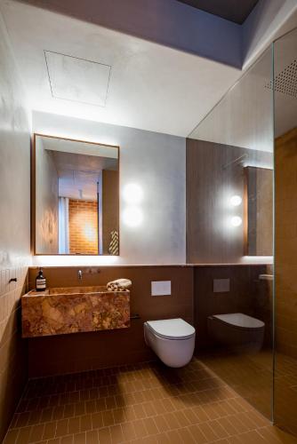 a bathroom with a tub and a toilet and a sink at Camperdown- Luxury Architectural Apartment Escape in Sydney