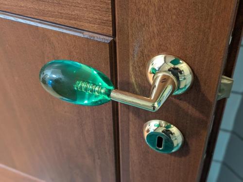 a green glass door knob on a wooden cabinet at Villa Girasole Luxury Amalfi Coast in Minori