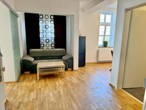 a living room with a couch and a table at Castle View Apartment 3 in Weilburg
