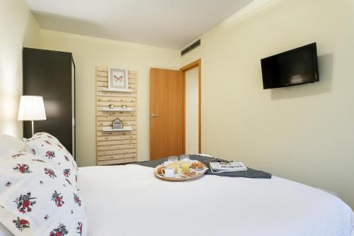 Postel nebo postele na pokoji v ubytování Apartamentos Cornellalux