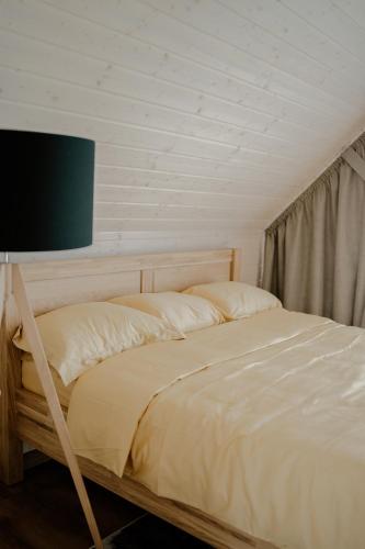 a bedroom with a bed with a tv on it at Chillzone u Grochów in Bieniowice