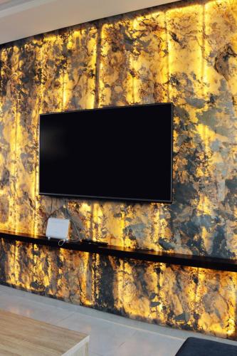 a television on a wall in a room at Evasion de luxe à Kénitra en face de la gare TGV in Kenitra
