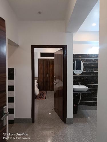 a bathroom with a toilet and a sink in a room at Magadh Homestay in Patna