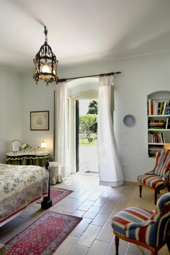 a bedroom with a bed and an open door at Colonna Country Home in Ururi