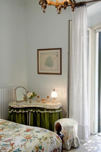 a bedroom with a bed and a table with a mirror at Colonna Country Home in Ururi