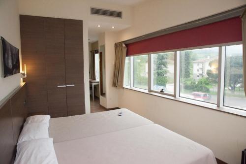 Postel nebo postele na pokoji v ubytování Hotel Izelai