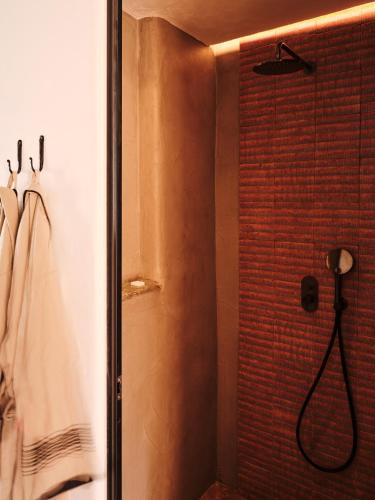 a bathroom with a shower with a shower head at The Wild by Interni in Kalafatis