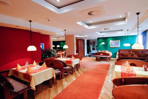 a restaurant with tables and chairs in a room at Hotel M3 in Sarajevo