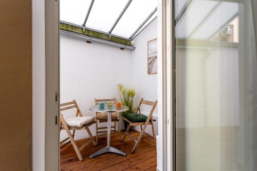a room with a table and chairs and a window at Celje City Stay in Celje