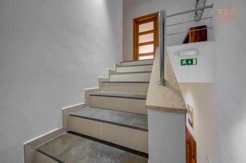 a staircase in a house with a price sign on it at A lovely 2BR home with a private balcony by 360 Estates in Marsaskala
