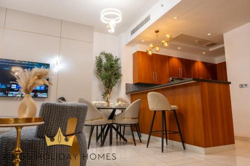 a kitchen and dining room with a table and chairs at Central Park towers Difc Royal suite kings in Dubai