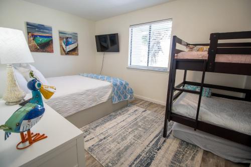 a bedroom with a bunk bed and a toy bird on a desk at Double Take! Renovated Vacation Home in Panama City Beach
