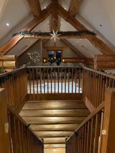 a wooden staircase in a restaurant with christmas decorations at Fir Lodge in Kings Lynn