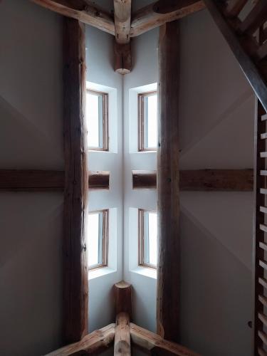 a group of windows in a room with wooden beams at Fir Lodge in Kings Lynn