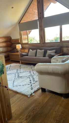 a living room with a couch and a rug at Fir Lodge in Kings Lynn