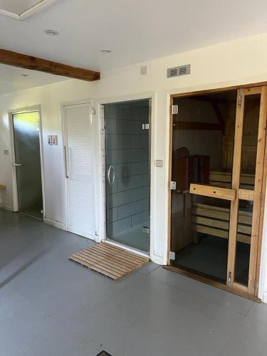 an empty room with a glass door in a room at Fir Lodge in Kings Lynn