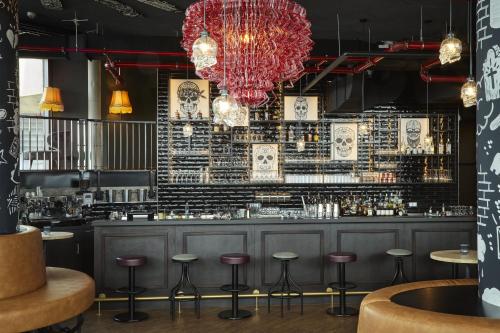 a bar with stools and a brick wall at REVERB by Hard Rock Hamburg in Hamburg