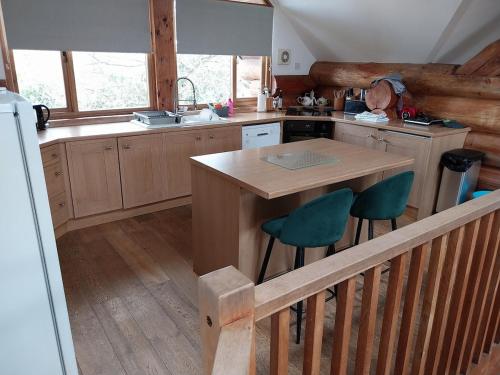 a kitchen with a table and chairs in a cabin at Fir Lodge in Kings Lynn