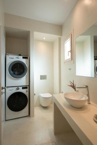 a bathroom with a washing machine and a sink at Villa Marilena Spetses - 8 Guests in Spetses