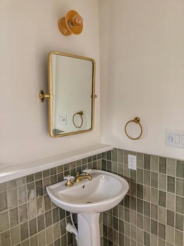 a bathroom with a sink and a mirror at The Clifftop Perch, 70ft above the dry Blanco in Wimberley