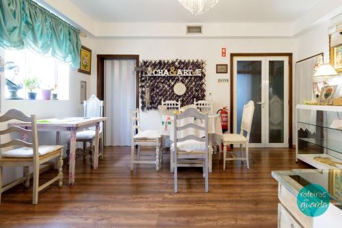 a dining room with a table and chairs at Borboleta Guest House in Figueira de Castelo Rodrigo