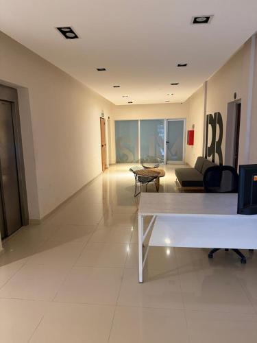 a living room with a couch and a table at Departamento 3 Habitaciones Zona Cincuentenario in Formosa