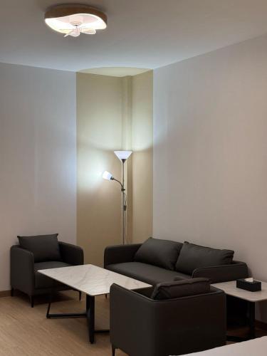 a living room with a couch and a table at Hotel Ivory Papar in Papar