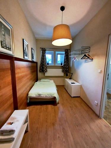 a small bedroom with a bed and a window at Hotel Gold in Poznań