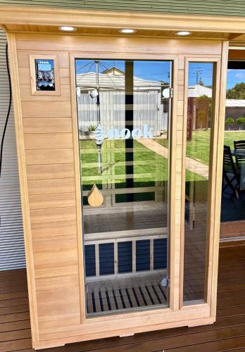 a screened in porch with a glass door at Stanley Stay - Sauna, Play set, WiFi, Central Location in Woodville