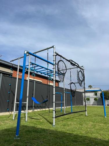 an empty playground with nets and swings at Stanley Stay - Sauna, Play set, WiFi, Central Location in Woodville