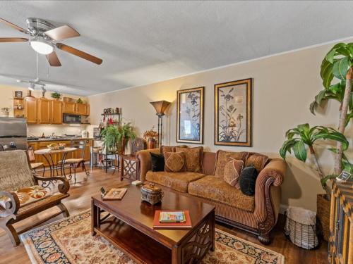 a living room with a couch and a table at College Park-Orlando 5Star Villa Oasis - Home Away From Home - QUIET Neighborhood-PRIVATE Botanical Courtyard - mins from EOLA,DT, Winter Park - Free Parking & EV Plug In in Orlando